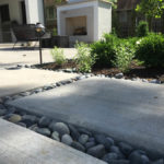customer concrete patio with river rock kc4