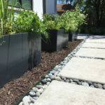 customer concrete patio with river rock kc3